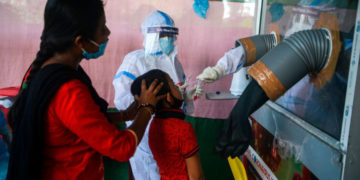 A health official collects nasal and throat swab samples from a girl to test for the Covid-19 coronavirus at a primary health centre  in Siliguri on September 2, 2020. - India on August 30 set a coronavirus record when it reported 78,761 new infections in 24 hours the world's highest single day rise even as it continued to open up the economy. (Photo by DIPTENDU DUTTA / AFP) (Photo by DIPTENDU DUTTA/AFP via Getty Images)