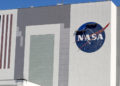 Workers near the top of the 526 ft. Vehicle Assembly Building at the Kennedy Space Center spruce up the NASA logo standing on scaffolds in Cape Canaveral, Fla., Wednesday, May 20, 2020. A SpaceX Falcon 9 rocket scheduled for May 27 will launch a Crew Dragon spacecraft on its first test flight with astronauts on-board to the International Space Station. (AP Photo/John Raoux)