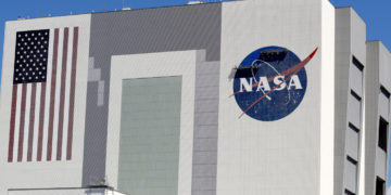 Workers near the top of the 526 ft. Vehicle Assembly Building at the Kennedy Space Center spruce up the NASA logo standing on scaffolds in Cape Canaveral, Fla., Wednesday, May 20, 2020. A SpaceX Falcon 9 rocket scheduled for May 27 will launch a Crew Dragon spacecraft on its first test flight with astronauts on-board to the International Space Station. (AP Photo/John Raoux)