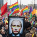 A demonstrator holds up a picture depicting Russian President Vladimir Putin with make-up during a protest by the gay community in Amsterdam in this April 8, 2013 file photo. Putin and his wife, Lyudmila, said on state television on Thursday that they had separated and their marriage was over after 30 years. REUTERS/Cris Toala Olivares/Files (NETHERLANDS - Tags: CIVIL UNREST SOCIETY POLITICS)