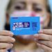 A person shows a vaccination card for the coronavirus disease COVID-19 at a vaccination centre in Santiago, on 10 January 2022. - Chile started administering today a fourth COVID-19 vaccine dose to people over the age of 12 with weakened immune systems. (Photo by Javier TORRES / AFP)