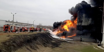 A still image taken from video footage shows members of the Russian Emergencies Ministry extinguishing a fire at a fuel depot in the city of Belgorod, Russia April 1, 2022. Russian Emergencies Ministry/Handout via REUTERS ATTENTION EDITORS - THIS IMAGE HAS BEEN SUPPLIED BY A THIRD PARTY. NO RESALES. NO ARCHIVES. MANDATORY CREDIT.