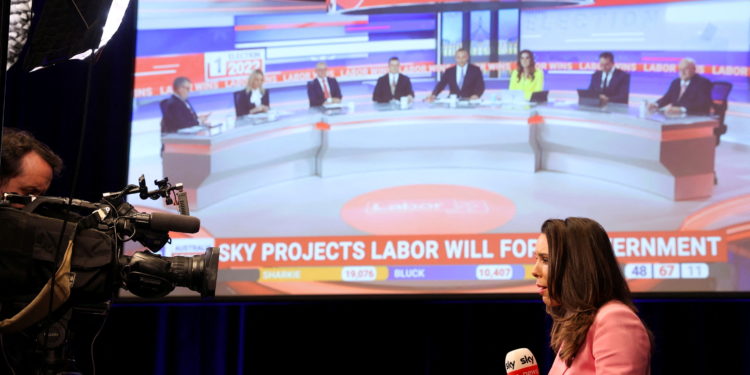 A TV presenter does a piece to camera with Sky News telecast up on the screen which projects that Anthony Albanese, leader of Australia's Labor Party, is going to be the next prime minister at Scott Morrison's election day event in Sydney, Australia May 21, 2022. REUTERS/Loren Elliott