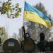 Ukrainian servicemen ride in an armoured vehicle near Kramatorsk September 5, 2014. Ukraine and pro-Russian rebels agreed a ceasefire on Friday, the first step towards ending fighting in eastern Ukraine that has caused the worst standoff between Moscow and the West since the Cold War ended. REUTERS/Gleb Garanich (UKRAINE - Tags: POLITICS CIVIL UNREST MILITARY CONFLICT)