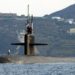 Port bow view showing US Navy (USN) Sailors manning a topside watch aboard the Los Angeles Class Attack Submarine USS NEWPORT NEWS (SSN 750), as the ship departs the harbor at Souda Bay, Crete, Greece following a port visit.