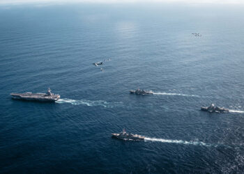 The U.S. Navy’s Gerald R. Ford Carrier Strike Group, including the flagship USS Gerald R. Ford (CVN 78), left, USS Winston S. Churchill (DDG 81), front, USS Mahan (DDG 72), back, USS Bainbridge (DDG 96), and embarked Carrier Air Wing Eight F/A-18E/F Super Hornets assigned to Strike Fighter Squadrons 31, 37, 87, and 213, operates as a joint, multi-domain force with a U.S. Air Force B-52 Stratofortress, Nov. 13, 2025. U.S. military forces, like the Gerald R. Ford Carrier Strike Group, are deployed in support of the U.S. Southern Command mission, Department of War-directed operations, and the President’s priorities to disrupt illicit drug trafficking and protect the homeland.