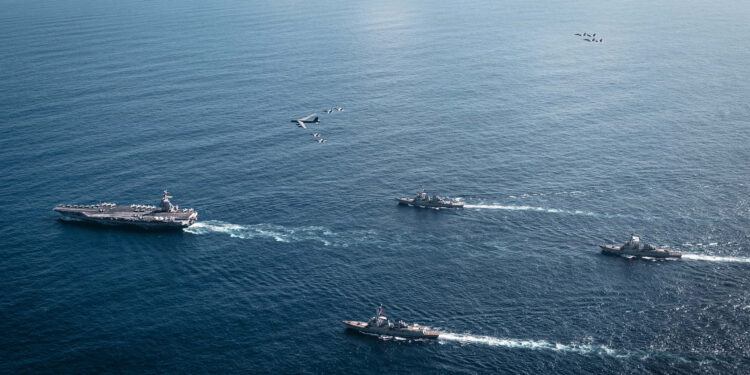 The U.S. Navy’s Gerald R. Ford Carrier Strike Group, including the flagship USS Gerald R. Ford (CVN 78), left, USS Winston S. Churchill (DDG 81), front, USS Mahan (DDG 72), back, USS Bainbridge (DDG 96), and embarked Carrier Air Wing Eight F/A-18E/F Super Hornets assigned to Strike Fighter Squadrons 31, 37, 87, and 213, operates as a joint, multi-domain force with a U.S. Air Force B-52 Stratofortress, Nov. 13, 2025. U.S. military forces, like the Gerald R. Ford Carrier Strike Group, are deployed in support of the U.S. Southern Command mission, Department of War-directed operations, and the President’s priorities to disrupt illicit drug trafficking and protect the homeland.